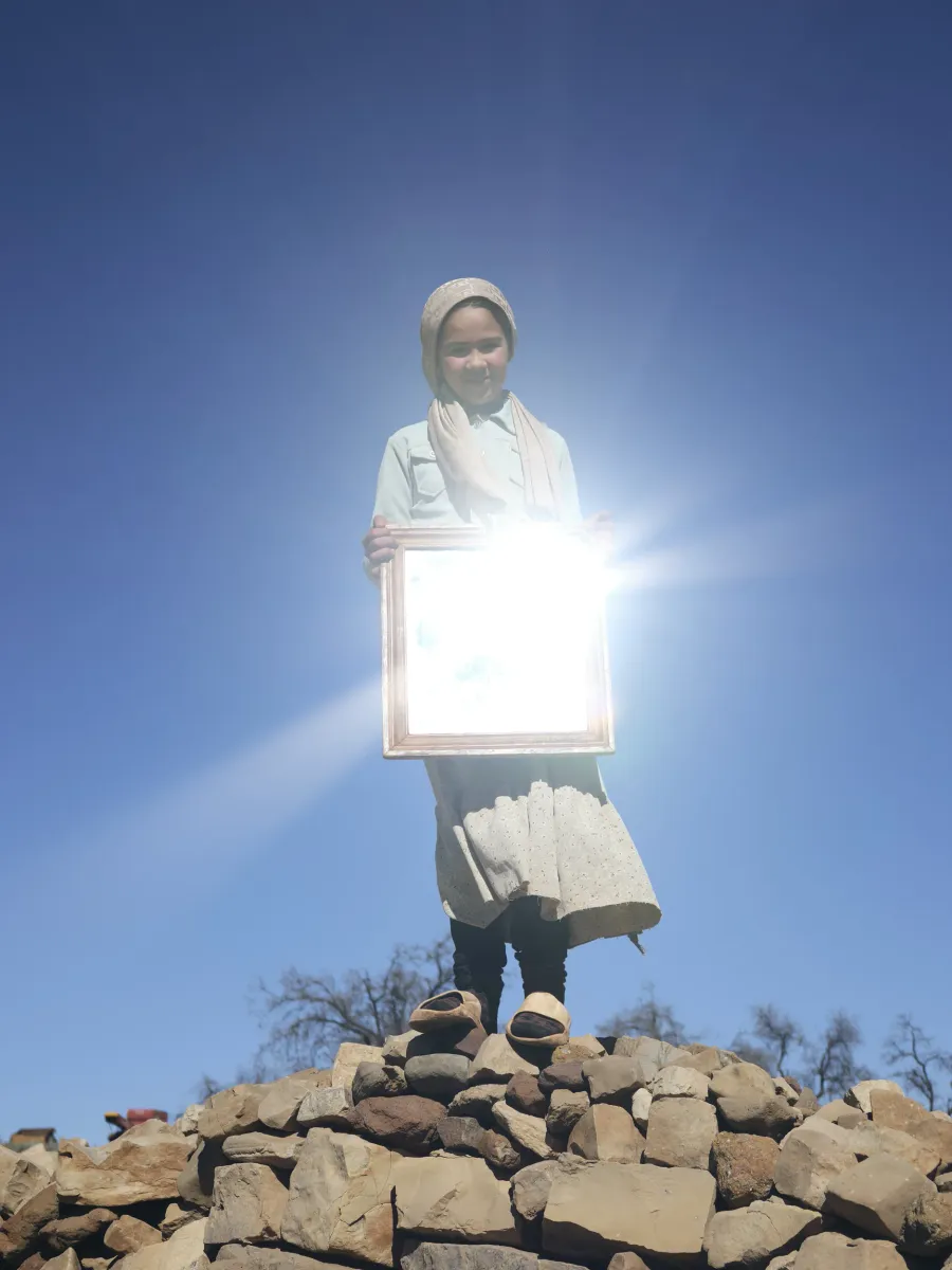 Lee-Ann Olwage, Marwa reflects the sun in a mirror from her childhood room, 2025